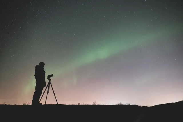 iceland, night sky, aurora borealis, silhouettes, photographer, northern lights, photography, camera, tripod, sky, night skies, stars, starry sky, starry night, stargazing, space, night, borealis, landscape, nature, natural phenomenon, astronomy. A stargazing camera kit checklist: what to carry, what to check