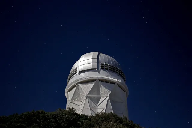 Stars over the Nicholas U. Mayall 4-meter Telescope at Kitt Peak National Observatory near Tucson, AZ. How Arizona light pollution laws affect stargazing near Flagstaff and Tucson