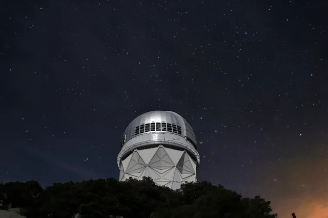 Stars over the Mayall 4-meter telescope at Kitt Peak National Observatory near Tucson, AZ. Arizona vs Utah astronomy tour prices, what each one includes
